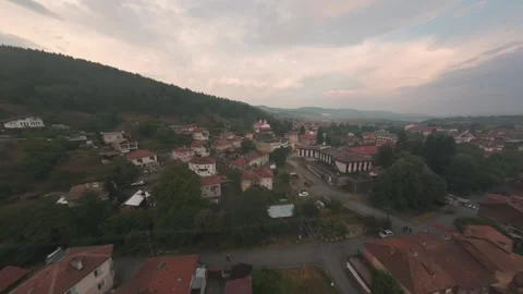 Aerial drone flight over Belitsa town approaching Orthodox church in Bulgaria. Stock Footage 343685805