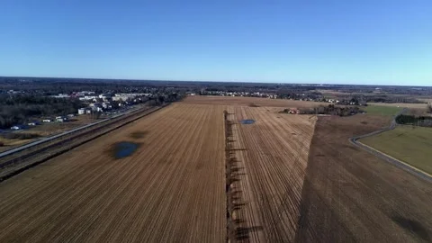 Aerial drone flight over countryside road and fields Stock Footage 332013180