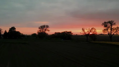 Aerial Drone Flight Over Dark Field Towards Colorful Sunset Horizon Video stock 324966982
