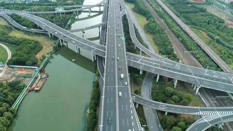Aerial drone flight over evening road traffic. Two-level road junction. Top view Video stock 252372576