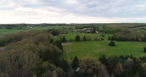 Aerial drone flight over fields and forest Stock Footage 106942618