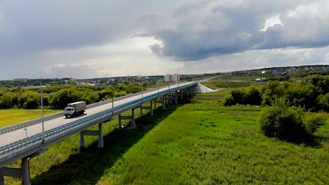 Aerial drone flight over the flyover, on which cars and trucks pass Stock Footage 129111700