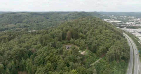 Aerial Drone Flight over Forested Hills, Highway Winding through Green Valley Vídeo Stock 340080630