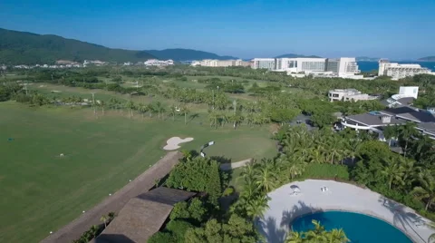 Aerial drone flight over a golf course on tropical Hainan island in China Stock Footage 67528944