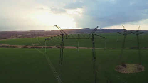 Aerial drone flight over green agricultural field with large electric power Stock Footage 153650109