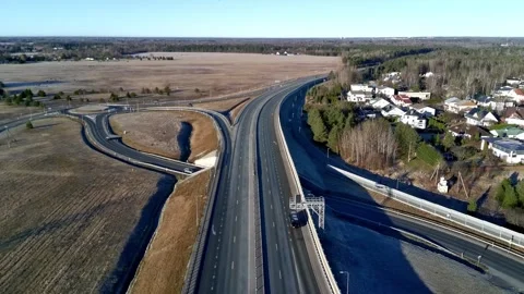 Aerial drone flight over highway interchange with rural landscape Stock Footage 332012755