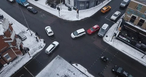 Aerial drone flight over an intersection in London, England during a snowstorm. Stock Footage 87168672