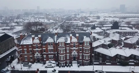 Aerial drone flight over an intersection in London, England during a snowstorm. Stock Footage 87168681