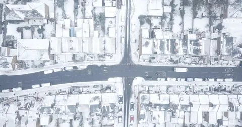 Aerial drone flight over an intersection in London, England during a snowstorm. Stock Footage 87168728