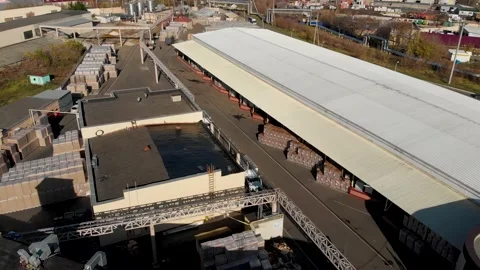 Aerial drone flight over a large warehouse with pallets finished products Stock Footage 130668293
