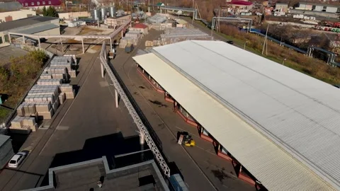Aerial drone flight over a large storage with pallets finished products Stock Footage 130668298