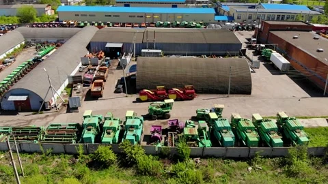 Aerial drone flight over a large parking lot of agricultural and cargo vehicles Stock Footage 130668417