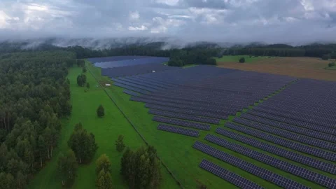 Aerial drone flight over large solar power plant under dramatic storm clouds Stock Footage 345689496