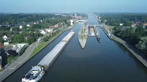 Aerial drone flight over lock and canal with boats, ships and barges. Video stock 160196833