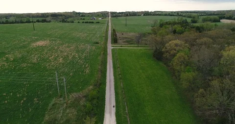 Aerial drone flight over meadows and road in rural area Stock Footage 107094461