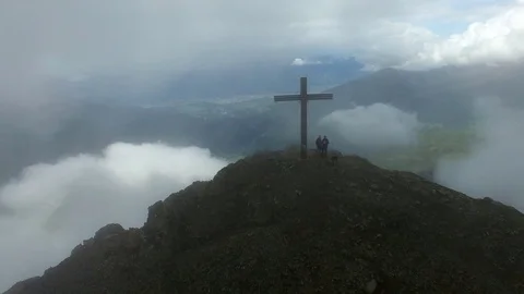 Aerial drone flight over mountain top summit with cross into scenic view of city 스톡 동영상 80595306
