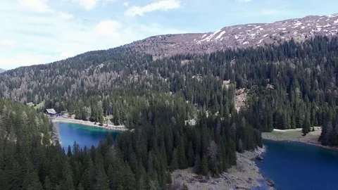 Aerial drone flight over mountain lake with fir tree woods and scenic background 스톡 동영상 80699942