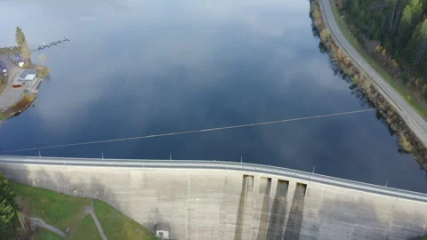 Aerial drone flight over a mountain lake dam surrounded by forest and hills Vídeos de archivo 321148243