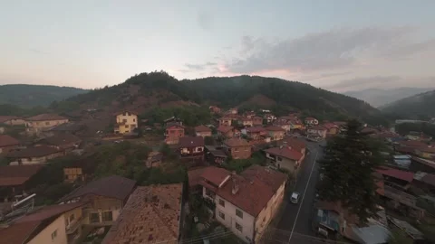 Aerial drone flight over mountain town of Belitsa at sunset in Bulgaria. Stock Footage 343686044