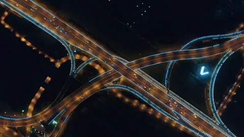 Aerial drone flight over night road traffic. Two-level road junction. Top view Stock Footage