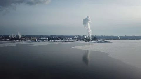 Aerial drone flight over a partially frozen lake with smoke pillar Stock Footage 103831207