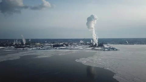 Aerial drone flight over a partially frozen lake with smoke pillar Stock-Footage 103831228