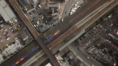 Aerial drone flight over railway and moving trains in central London, England. Stock Footage