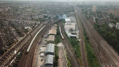 Aerial drone flight over railway and moving trains in central London, England. Video stock 90455877