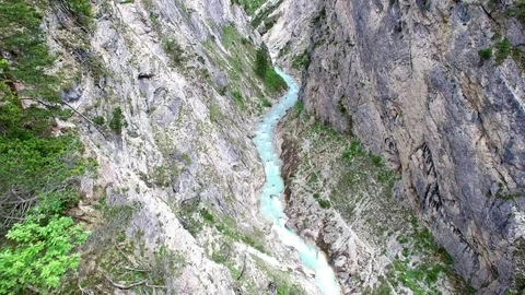 Aerial drone flight over river in a valley with rocks between green fir tree 스톡 동영상 80556273