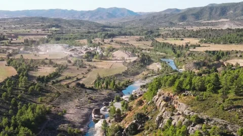 Aerial Drone Flight Over River and Factory Amidst Nature Stock Footage 263028628