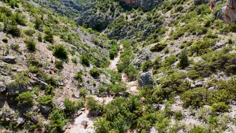 Aerial drone flight over rocky canyon and dry riverbed Stock Footage 337628482