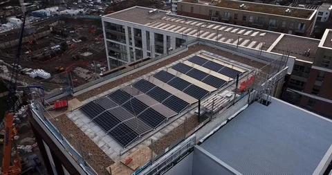 Aerial drone flight over  rooftops covered in solar panels London England. Video stock 86007816