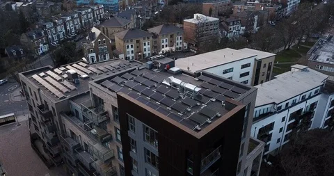 Aerial drone flight over  rooftops covered in solar panels London England. 스톡 동영상 86009203