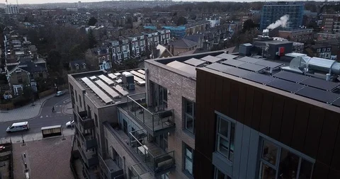 Aerial drone flight over  rooftops covered in solar panels London England. Stock-Footage 86009423