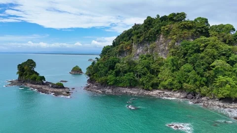 Aerial drone flight over small vegetated islet near Playa La Macha, Costa Rica Stock Footage 328171635