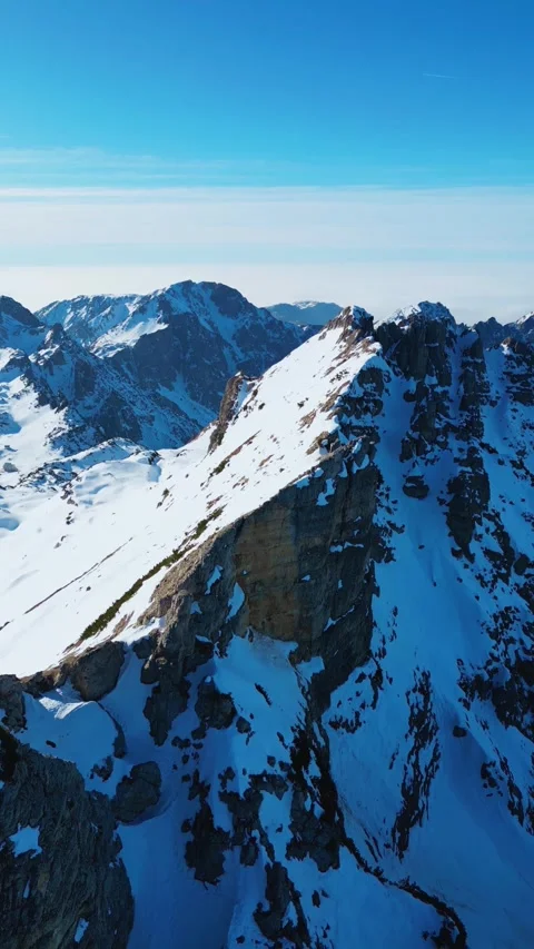 Aerial Drone Flight Over Snowy Mountain Peaks in 4K Stock Footage 314879901