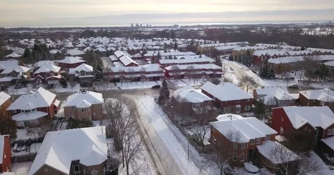 Aerial drone flight over suburban neighborhood covered with snow. Видео 83734262