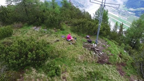 Aerial drone flight over summit cross with young girl with smart phone and 스톡 동영상 80540365