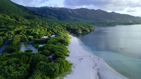 Aerial Drone Flight Over Tropical White Sand Spit and Lush Mountain Coastline Stock Footage 333982545