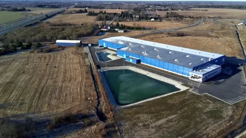 Aerial drone flight over warehouse roof and industrial building Stock Footage 332013174