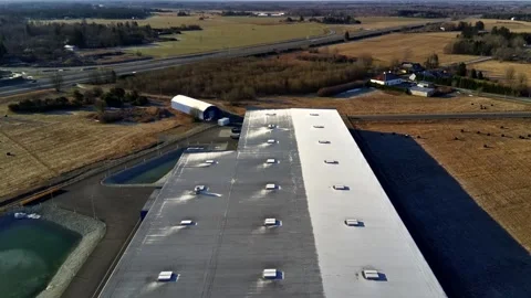 Aerial drone flight over warehouse roof and industrial building Stock Footage 332013181