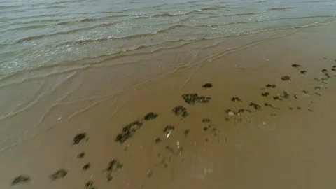 Aerial drone flight over waves on British beach, Liverpool Stock-Footage 111573804