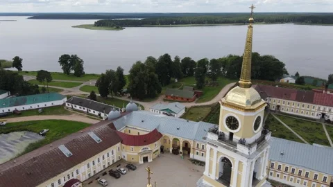 Aerial drone flight path past the golden domes of Nilov Monastery Stock Footage 338103386
