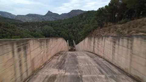Aerial drone flight through Conde de Guadalhorce-Gaitanejo reservoir water slide Stock Footage 294627239