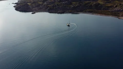 Aerial Drone Flight Tracking Sailboat Through Calm Arctic Waters Along Remote Stock Footage 346354788