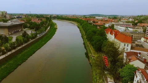Aerial drone flight view of the river dividing the city. Distant mountains on 스톡 동영상 105272223