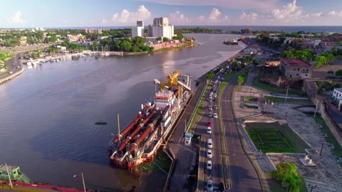 Aerial Drone Fly Backward and Orbit over Power Barge and Ozama River Stock Footage 344917630