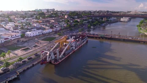 Aerial Drone Fly Forward and Orbit over Industrial Barge on Ozama River Stock Footage 344917664