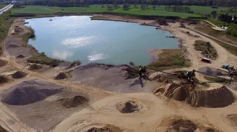 Aerial Drone fly Over open pit sand quarries with small lake Stock Footage 62927897