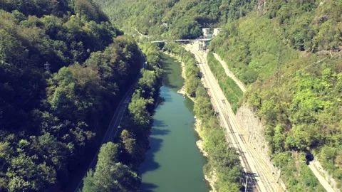 Aerial drone fly over the river and railways near the Trbovlje power station. Video stock 221100410
